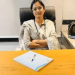 "Dr. Monika Raghuwanshi, Obstetrician and Gynecologist, seated in her clinic office."
