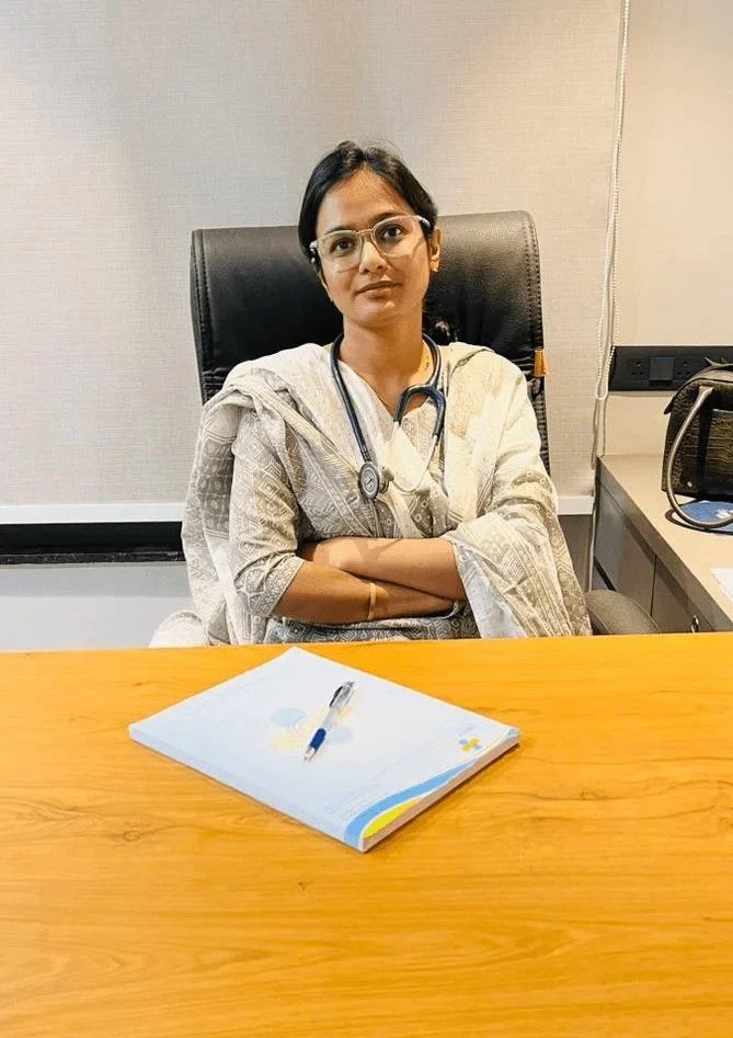 "Dr. Monika Raghuwanshi, Obstetrician and Gynecologist, seated in her clinic office."